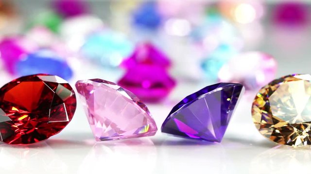 Blue Diamond,tourmaline pink,Amethyst Purple,Citrine Yellow,Iolite smokey blue,
Topaz lighter blue,Peridot green,and colorful gems in white background.

