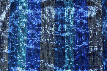 Abstract blue spangles background. Fabric texture with bright blue  circles beads or sequins.