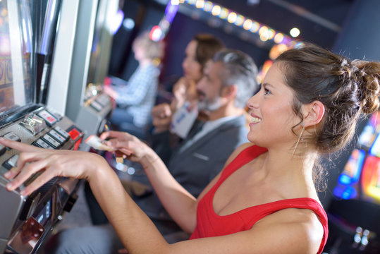 woman happy after winning on slot machine at casino