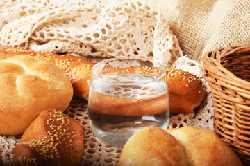 fresh crunchy bread rolls and a glass of puremineral water