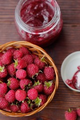 Raspberries and raspberry jam in a wooden basket  