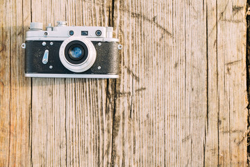 35mm Vintage Old Retro Small-Format Rangefinder Camera On Old Wooden