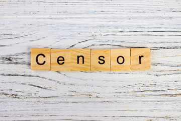 CENSOR word made with wooden blocks on the table