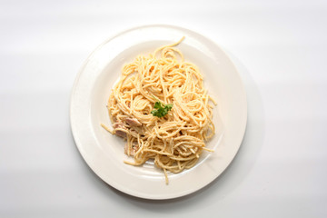 spaghetti carbonara with cream on white plate