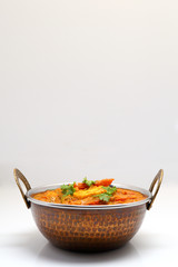 Indian Food or Indian Curry in a copper brass serving bowl.