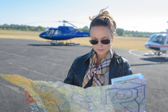 woman helicopter pilot reading map