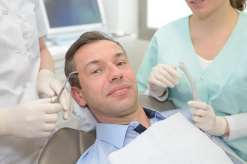 Fototapeta premium entist and happy man in a dentist office