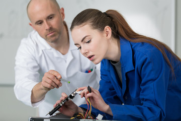 young woman learning to solder wire