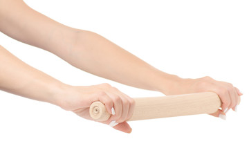 Female hand holding a kitchen rolling pin isolated