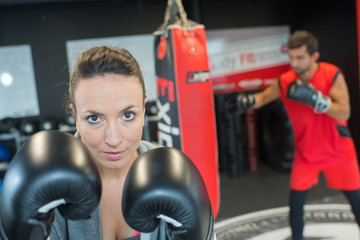 young attractive woman boxer training in a gym