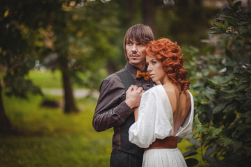 close-up of romantic couple hugging and kissing on blurred nature background