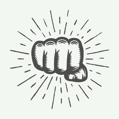 Retro fist in vintage style with sunburst. Graphic art. Vector illustration.