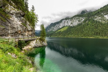 Fototapeta na wymiar Great azure alpine lake Vorderer Gosausee. Picturesque and gorgeous rain clouds