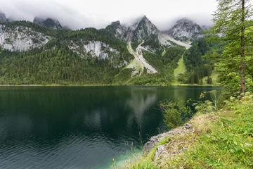 Fototapeten Great azure alpine lake Vorderer Gosausee. Picturesque and gorgeous rain clouds © radu79