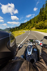 Naklejka premium Detail of motorcycle handlebars. Outdoor photography, Alpine landscape