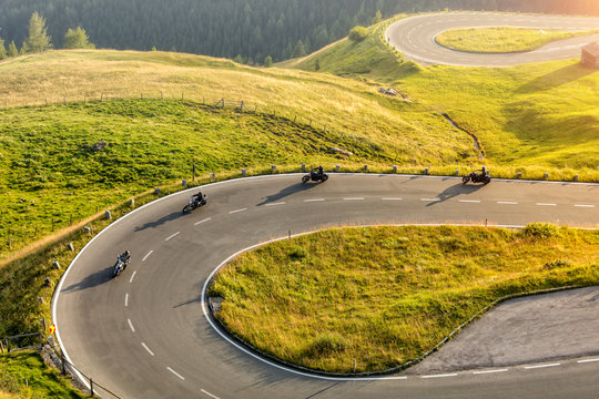 Fototapeta Motorcycle drivers riding in Alpine highway. Outdoor photography