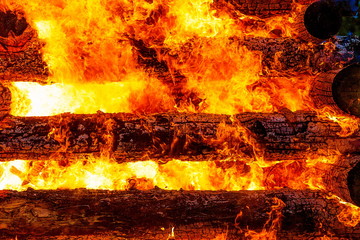 beautiful structure of burning logs and flames of great bonfire.