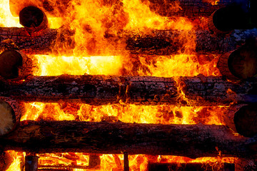 beautiful structure of burning logs and flames of great bonfire.