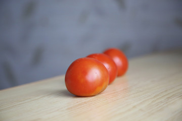 fresh tomatoes on the table with wood texture