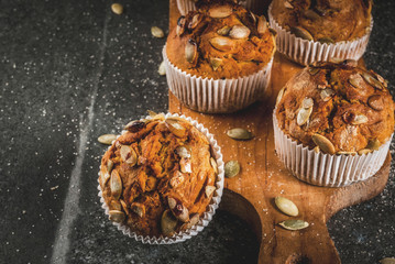 Autumn and winter baked pastries. Healthy pumpkin muffins with traditional fall spices, pumpkin...
