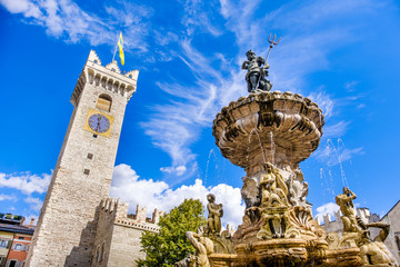 Fontana del Nettuno (Neptune fountain) in Trento and the Torre Civica or Torre di Piazza - obrazy, fototapety, plakaty