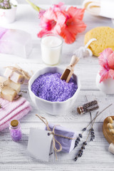 Wellness setting. Sea salt in bowl, towels,