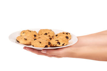 Pile of chocolate chip cookies on a dish in hand isolated on white background