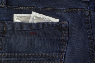 Condom in the pocket of a blue jeans. Condoms