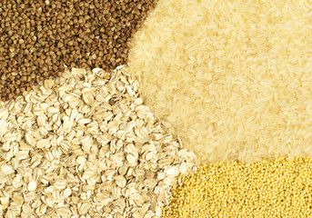 Horizontal background: millet, rice and buckwheat grains and oat flakes