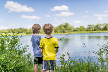 Two boys fishing on the lake - Powered by Adobe