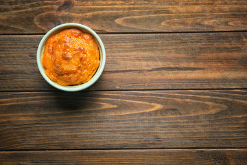 Ramekin with tasty carrot souffle on wooden table