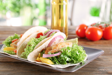 Plate with delicious fish tacos on kitchen table