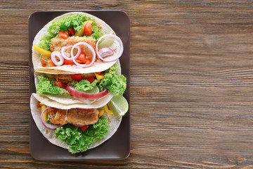 Plate with delicious fish tacos on kitchen table