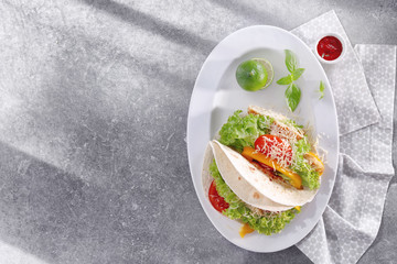 Plate with delicious fish tacos on kitchen table