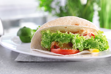 Plate with delicious fish tacos on kitchen table
