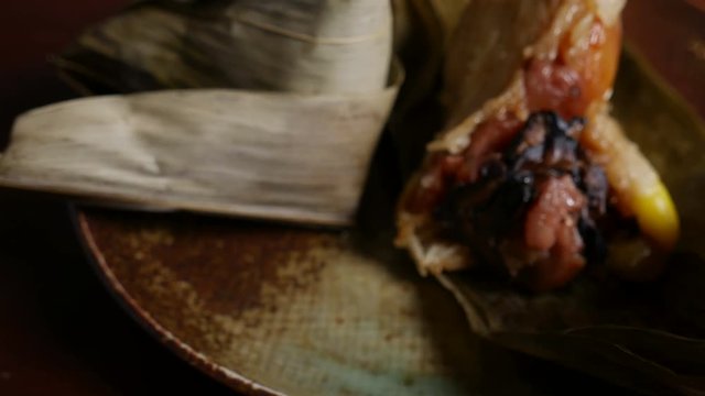 'Zongzi' or 'bakcang', 'bacang' a Chinese traditional food made of glutinous rice  with different fillings and wrapped in bamboo or large leaves.