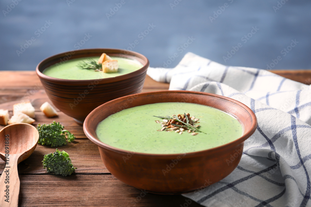 Wall mural bowl with delicious broccoli soup on table