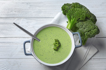 Tureen with delicious broccoli soup on table