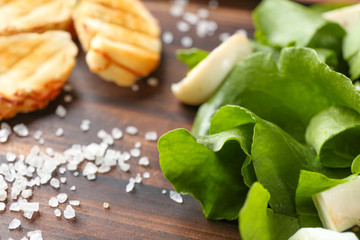 Salad with quail egg and spinach on wooden board