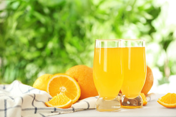 Freshly squeezed orange juice in glasses on table