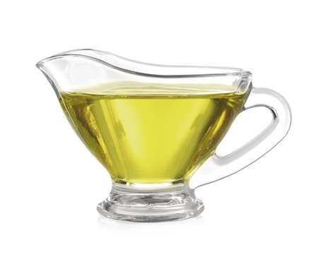 Glass gravy boat with hemp oil isolated on white