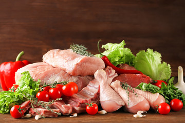 Pieces of different fresh meat on kitchen table