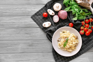 Composition with delicious turkey tetrazzini on wooden background