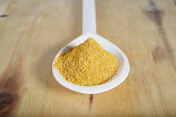 A pinch of curry on a wooden spoon. 