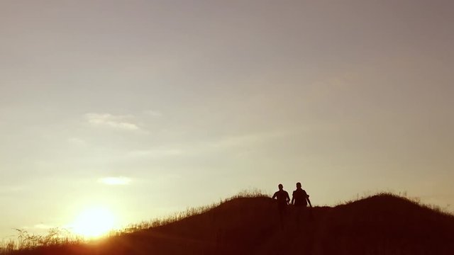 people group of tourists walking on top of a sunset travel silhouette mountain. slow video tourists people group go nature