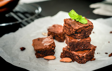 Brownie stack, closeup chocolate cake in plate on rustic wooden table