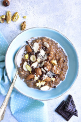 Chocolate oat porridge with nuts.Top view.