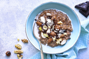 Chocolate oat porridge with nuts.Top view.