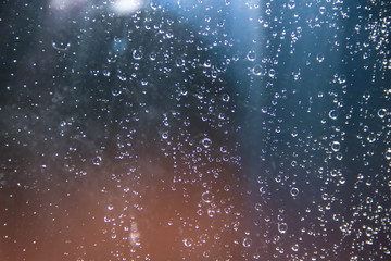 Rain drops on the glass on a blue background