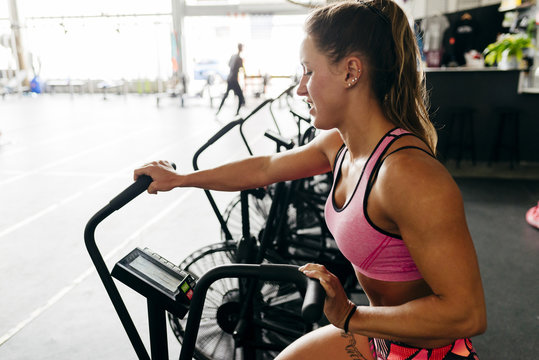 Concentrated woman working out on exerciser